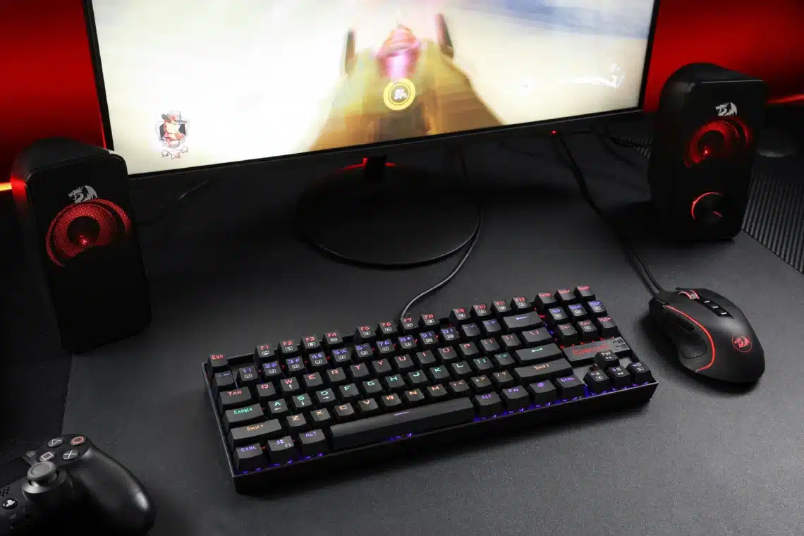 Teclado y monitor de un montaje gaming para PC, luces oscuras y ambiente de escritorio